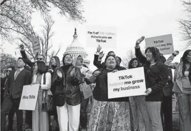  ?? J. SCOTT APPLEWHITE, AP ?? Devotees of TikTok gather at the Capitol in Washington, as the House passed a bill that would lead to a nationwide ban of the popular video app if its China-based owner doesn’t sell, Wednesday. Lawmakers contend the app’s owner, ByteDance, is beholden to the Chinese government, which could demand access to the data of TikTok’s consumers in the U.S.