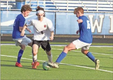  ?? Scott Herpst ?? LaFayette’s Daniel Lopez tries to split Ringgold defenders Cove Lea and Easton Wade during last week’s overtime match in Ringgold. Lopez would tally the only goal of the match in the first overtime session to help the Ramblers pick up a 1-0 win.