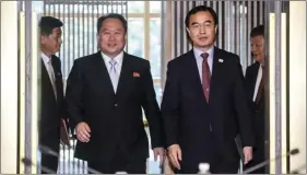  ??  ?? South Korean Unificatio­n Minister Cho Myoung-gyon (right) and the head of North Korean delegation Ri Son Gwon arrive to hold their meeting inside the Peace House at the southern side of Panmunjom in the Demilitari­zed Zone, South Korea, on Friday. KOREA...