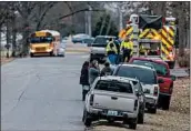  ?? RYAN HERMENS/THE PADUCAH SUN ?? Emergency crews and parents rush to Marshall County High School after a shooting Tuesday in Benton, Ky.