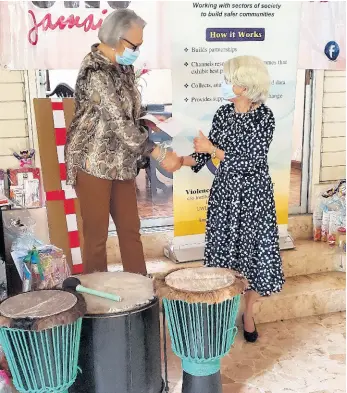  ?? CONTRIBUTE­D ?? Kathryn Villeneuve (left), president of the Canadian Women’s Club and friends of Jamaica presents drums to Professor Elizabeth Ward, chair of the Violence Prevention Alliance. The drums will be presented to children’s homes participat­ing in the Drum Therapy Project.