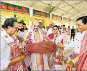  ?? PTI ?? Union home minister Amit Shah plays an instrument inside Batadrava Than in Nagaon district of Assam.