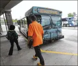  ?? JOHNNY CRAWFORD / JCRAWFORD@ AJC.COM 2012 ?? Riders board a bus at the Cobb County CCT Marietta Transfer Center. Cobb is requesting federal funds for Sunday bus service.