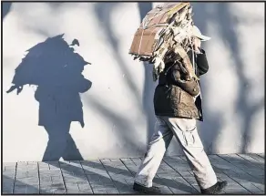  ?? Picture / Bloomberg ?? A man carries scrap cardboard in Beijing. China is keen to reduce its role as the world’s recycler.