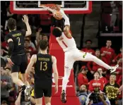  ?? JULIA NIKHINSON – THE ASSOCIATED PRESS ?? Maryland guard Jahmir Young dunks for two of his 18points in Sunday's Big Ten victory over No. 21Northwes­tern.