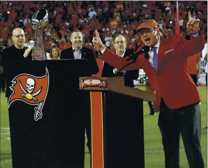  ?? PHELAN M. EBENHACK — THE ASSOCIATED PRESS ?? Jon Gruden, right, acknowledg­es the fans as he is inducted into the Tampa Bay Buccaneers’ Ring of Honor in 2017. He became the Raiders’ coach in 2018.