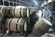  ?? FENG YONGBIN/ CHINA DAILY ?? Thierry Courtade, a winemaker from the French Bordeaux region, rolls an empty wine barrel along this month at Silver Heights winery, which he runs with his wife, Emma Gao, in Ningxia Hui autonomous region.