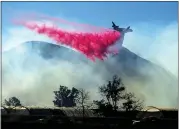  ?? NOAH BERGER — THE ASSOCIATED PRESS ?? An air tanker drops retardant as the Maria fire approaches Santa Paula on Friday. According to the Ventura County Fire Department, the blaze has burned nearly 15square miles and forced nearly 11,000 people to evacuate.