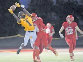  ?? JIM RASSOL/STAFF PHOTOGRAPH­ER ?? American Heritages’ Miles Jones goes up for a pass during Friday night’s game. He returned a 95-yard kickoff-return to give the Patriots their first score of the game.