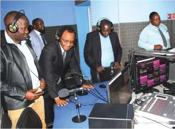  ??  ?? Legislator­s have a feel of Diamond FM equipment during their tour of the station on Tuesday.