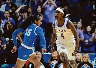  ?? Gerald Herbert/Associated Press ?? LSU guard Flau’jae Johnson, right, reacts after scoring a 3-point basket during the first half against Middle Tennessee on Sunday in the second round of the women’s NCAA Tournament. Johnson had 21 points.