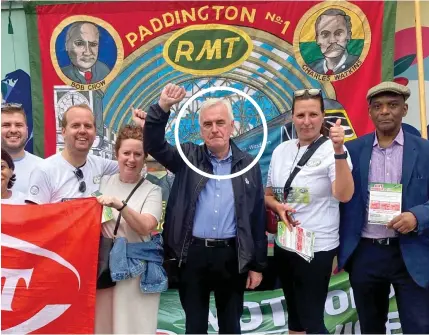  ?? ?? Corbynite former shadow chancellor John McDonnell, circled, raises his fist at Paddington, London