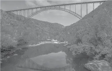  ?? F. BRIAN FERGUSON/CHARLESTON GAZETTE-MAIL ?? The New River Gorge Bridge is seen in October 2019 from Fayette Station in Fayettevil­le, W.VA. A West Virginia program that offers cash incentives for out-of-state workers to move to the state has opened up applicatio­ns.