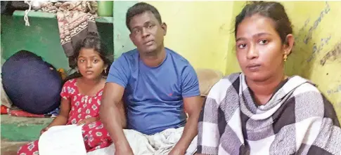  ??  ?? Manikandan along with his elder daughter Anupriya (left) and youngest daughter Vinodhini at his house at K.M Garden on Wednesday.