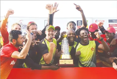  ??  ?? WHAT A GOOD FEELING . . . Zimbabwean cricketers celebrate after winning an historic ODI cricket series in Sri Lanka yesterday.