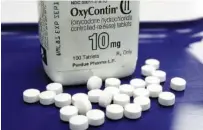  ?? AP FILE PHOTO/TOBY TALBO ?? OxyContin pills are seen at a pharmacy in Montpelier, Vt. The global business consulting firm McKinsey & Co. has agreed to a $573 million settlement over its role in the opioid crisis.
