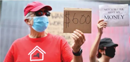  ?? ANGELA WEISS/AFP/GETTY IMAGES ?? Protesters rally demanding economic relief during the pandemic at New York City’s Times Square on Aug. 5.