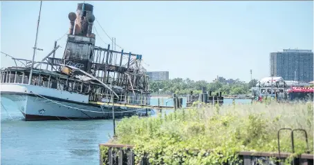  ?? PHOTOS: BEN ALLAN SMITH/ANN ARBOR NEWS ?? The SS Ste. Claire lists port side after burning at Detroit’s Riverside Marina on Friday. The SS Ste. Claire, which was used to ferry passengers to the Boblo Island amusement park, was in service for 81 years and made her last run in 1991.