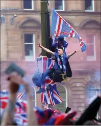  ??  ?? Rangers fans climb lampposts in George Square