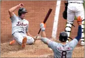  ?? GENE J. PUSKAR — THE ASSOCIATED PRESS ?? Detroit Tigers' Kerry Carpenter, left, scores on a single by Jake Rogers off Pittsburgh Pirates relief pitcher David Bednar during the ninth inning in Pittsburgh on Tuesday. The Tigers won 5-3.