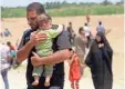  ?? HADI MIZBAN, AP ?? Displaced Iraqis from Ramadi walk toward Baghdad on Saturday.