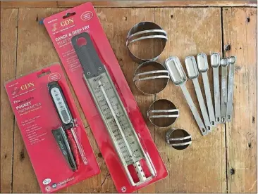  ?? ADDIE BROYLES / AMERICAN-STATESMAN ?? Simple kitchen gadgets — such as a thermomete­r, biscuit cutters and measuring spoons — are the kind of useful gifts that can make a cook’s life easier.