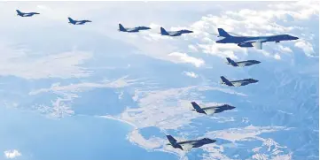  ??  ?? This handout taken and released by the South Korean Defence Ministry in Seoul shows a US Air Force B-1B Lancer bomber (right top), two US F-35A (centre) and two US F-35B (bottom) stealth jets flying over South Korea with South Korea’s two F-16 (left)...