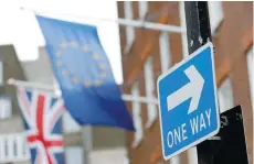  ?? — Reuters ?? A traffic sign is seen in front of European and Union flags in London.