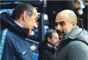  ??  ?? Chelsea manager Maurizio Sarri, left, speaks with Man City manager Pep Guardiola before the game between the two teams on Sunday Photo: AP