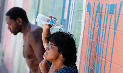  ?? ?? People try to cool off in downtown Phoenix in July. Photograph: Matt York/AP