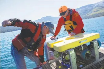  ?? Photos by Santiago Mejia / The Chronicle ?? Keith Cormican and John Soderman, above, prepare a remotely operated underwater vehicle (ROV) at Fallen Leaf Lake, right, near Lake Tahoe, where drowning victims often aren’t found.