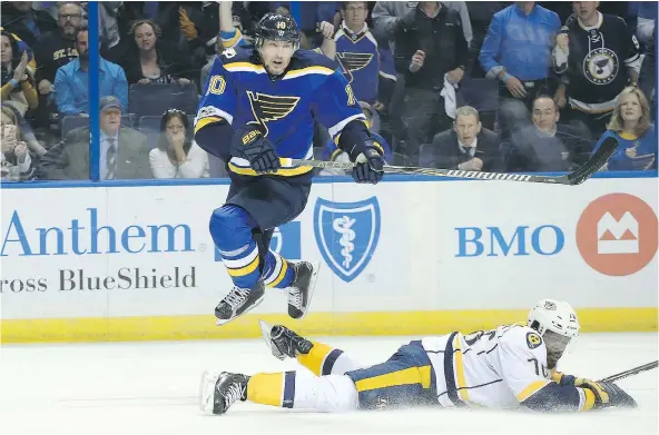  ?? — PHOTOS: GETTY IMAGES FILES ?? Blues forward Scottie Upshall leaps over Nashville’s P.K. Subban during last season’s playoffs. The winger thought his time in St. Louis was over after the team failed to sign him but he ended up back there when injuries hit the club.