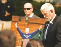  ?? STAFF PHOTO BY MATT HAMILTON ?? Georgia state senator Chuck Payne, right, speaks during the Tony Ingle memorial as city administra­tor Jason Parker holds a photo of the former Dalton State coach Monday at the Dalton Convention Center.