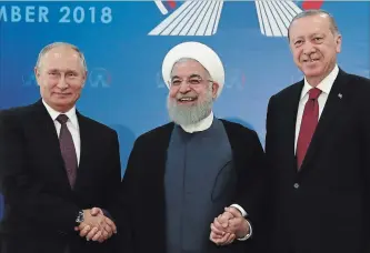  ?? THE ASSOCIATED PRESS ?? Iran's President Hassan Rouhani, flanked by Russia's President Vladimir Putin and Turkey's President Recep Tayyip Erdogan, were photograph­ed in Tehran, Iran, ahead of their summit Friday to discuss Syria.