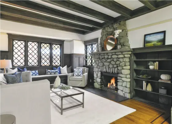  ?? Open Homes Photograph­y ?? Built-in shelving at 990 Vermont St. in Oakland flanks the living room’s stacked stone wood-burning fireplace.
