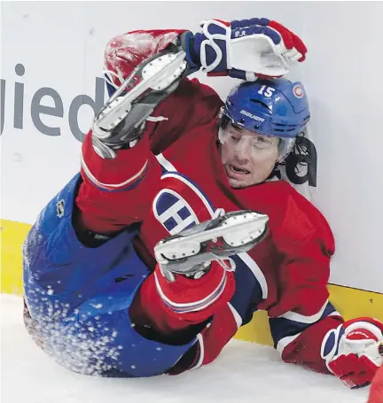  ?? J O H N K E N N E Y/ MO N T R E A L G A Z E T T E F I L E S ?? P. A. Parenteau of the Habs hits the back boards after being upended by a Red Wings player at the Bell Centre in 2014. Parenteau was sidelined for months after a concussion in January — a situation which experts say can trigger emotions not unlike...