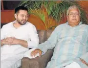  ?? PTI FILE ?? RJD chief Lalu Prasad with his son and Bihar deputy chief minister Tejashwi Yadav at a party legislator­s meeting in Patna.