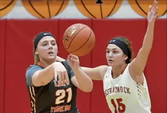  ?? Matt Freed/Post-Gazette ?? Josalind Dennison of Beaver Falls dishes while guarded by Neshannock’s Bella Burrelli Monday night at Neshannock High School.