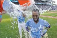  ?? AP PHOTO/CHARLIE RIEDEL ?? Kansas City Royals' Samad Taylor (0) is doused by teammates after their baseball game against the Los Angeles Angels on Saturday in Kansas City, Mo. The Royals won 10-9.