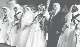  ?? REUTERS/Jonathan Ernst ?? U.S. President Donald Trump dances with a sword as he arrives to a welcome ceremony by Saudi Arabia’s King Salman bin Abdulaziz Al Saud at Al Murabba Palace in Riyadh, Saudi Arabia May 20, 2017.