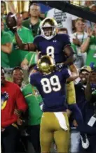  ?? PAUL SANCYA — THE ASSOCIATED PRESS ?? Notre Dame’s Jafar Armstrong (8) celebrates his 4-yard touchdown run with Brock Wright (89) in the first half in South Bend, Ind., Saturday.