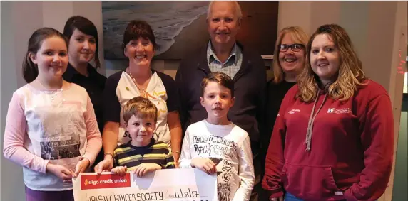  ??  ?? The McDonald and McGauran Families from Calry presenting a cheque for €2,700 to Ena Barrett of The Irish Cancer Society. The money was raised from their annual “Coffee at Le-Cachot” fundraiser, in memory of Josie McGauran and Marian McDonald. Pictured...