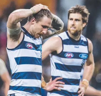  ?? Picture: TONY McDONOUGH ?? TOUGH LOSS: Zach Tuohy and Tom Lonergan ponder Geelong’s loss to West Coast.