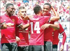  ?? AFP ?? Manchester United forward Anthony Martial (right) celebrates after setting up a goal for Jesse Lingard (centre) against Real Madrid in their Internatio­nal Champions Cup match on Sunday.