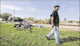  ?? JAMES EDWARD BATES / FOR AMERICAN-STATESMAN ?? Tyrone Burton, 75, returns Wednesday to the scene of Tuesday’s fatal accident involving a bus and train in Biloxi, Miss. More than half the passengers — 27 — were members of the Bastrop Senior Center, Bastrop police said.