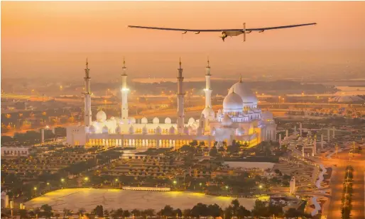  ??  ?? Solar Impulse 2 flies over the Shaikh Zayed Grand Mosque in Abu Dhabi during preparatio­ns for its round-the-world flight, in February last year. — Reuters file