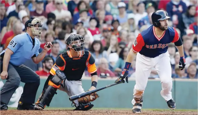  ??  ?? BOSTON: Boston Red Sox’s Mitch Moreland runs on a single in front of Baltimore Orioles’ Caleb Joseph during the seventh inning of a baseball game in Boston, Saturday. —AP