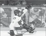  ?? AP PHOTO ?? Canada’s Brad Bowden celebrates with teammates after a goal during an ice sledge hockey match against the Czech Republic at the 2014 Winter Paralympic­s in Sochi, Russia, Tuesday, March 11, 2014.