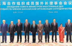  ?? AFP PHOTO ?? Foreign minister Sushma Swaraj (second from right) poses for a group photo with her counterpar­ts and other officials before a meeting at the Diaoyutai State Guest House in Beijing on Tuesday.