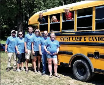  ?? Janelle Jessen/Herald-Leader ?? The new owners of Gypsy Camp and Canoe stood in front of one of the business’ shuttle buses, which takes customers up the river to the Siloam Springs Kayak Park so they can float back down to the camp. Pictured, from left, are Jerrid and Tracie...